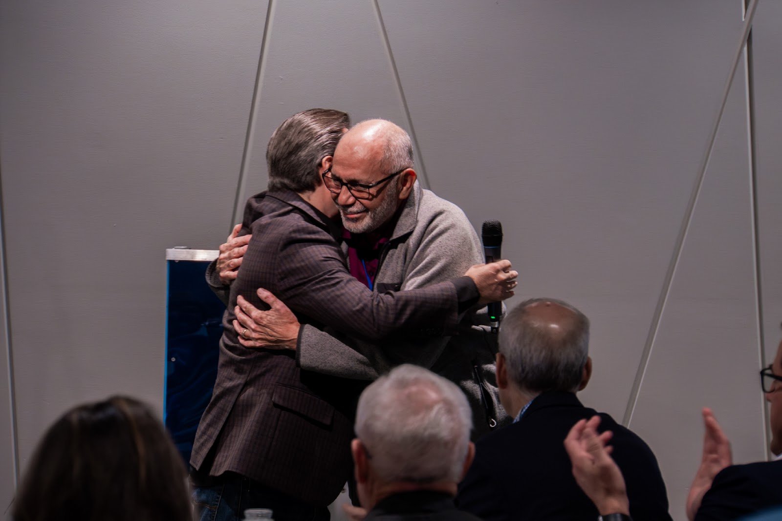 Ministry leaders embracing at Barnabas Collective event